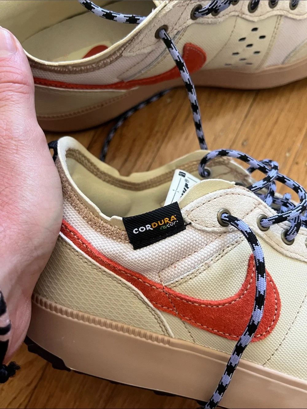 Nike Men's Cream Sneakers with Orange Swoosh and Black Accents